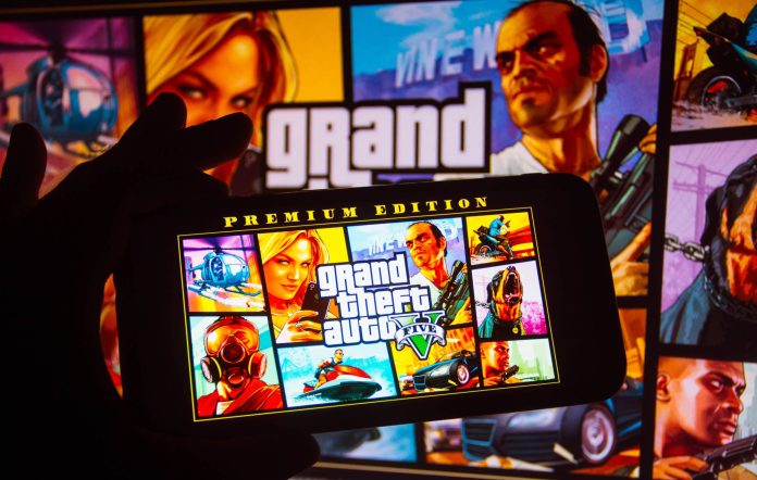 In this photo illustration the Grand Theft Auto (GTA) logo seen displayed on a smartphone. (Photo Illustration by Rafael Henrique/SOPA Images/LightRocket via Getty Images)